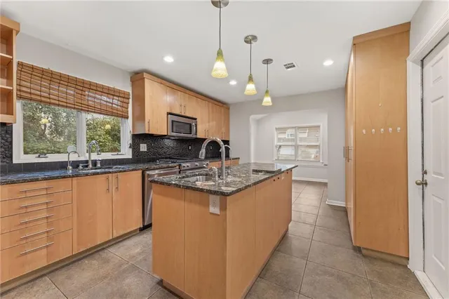 a kitchen with stainless steel appliances granite countertop a stove and a refrigerator