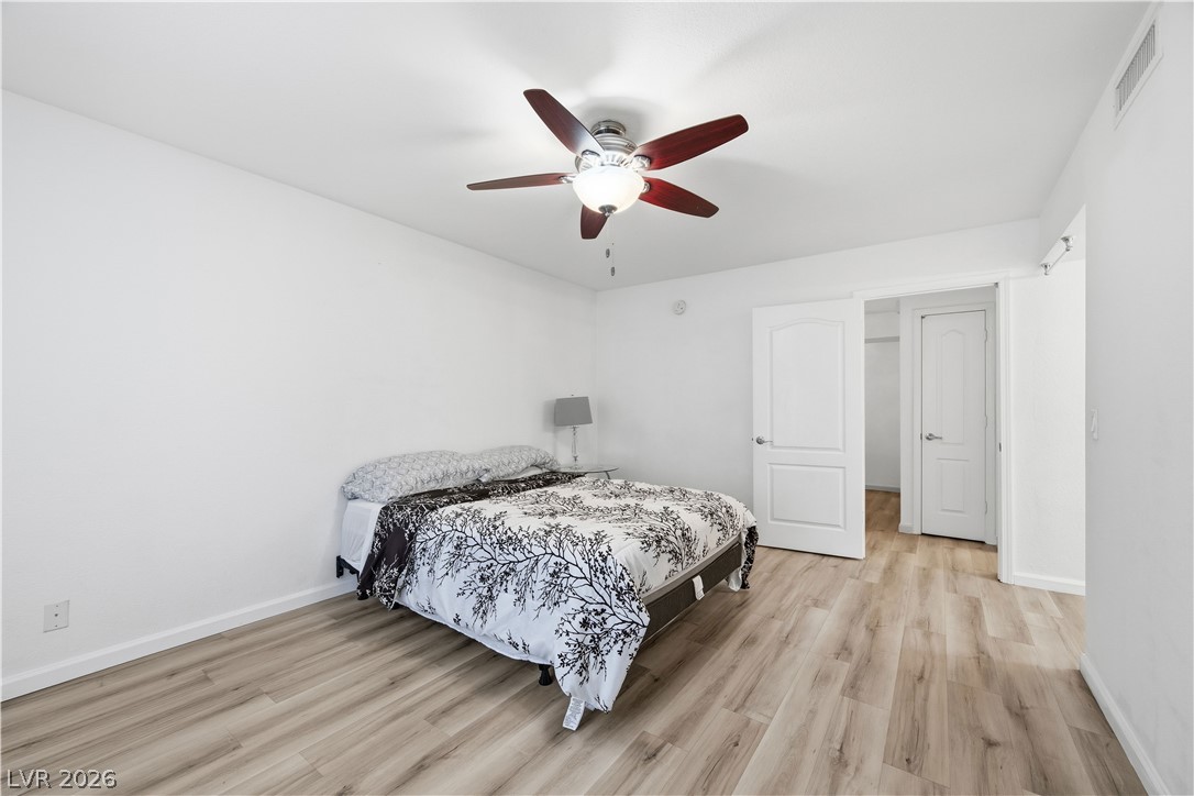 2838 Geary Place, Unit 4017 Las Vegas, NV 89109 - Photo 15 of 31 The primary bedroom stands out with its high ceiling, elegant luxury plank flooring, and two walk-in closets that make staying organized simple.