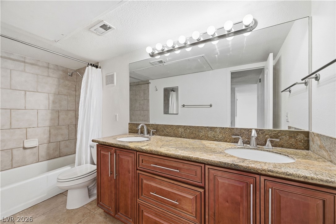 2838 Geary Place, Unit 4017 Las Vegas, NV 89109 - Photo 19 of 31 This bathroom offers a comfortable blend of style and function, featuring a double vanity, ample drawer space, and a relaxing tub/shower combo for unwinding at the end of the day.