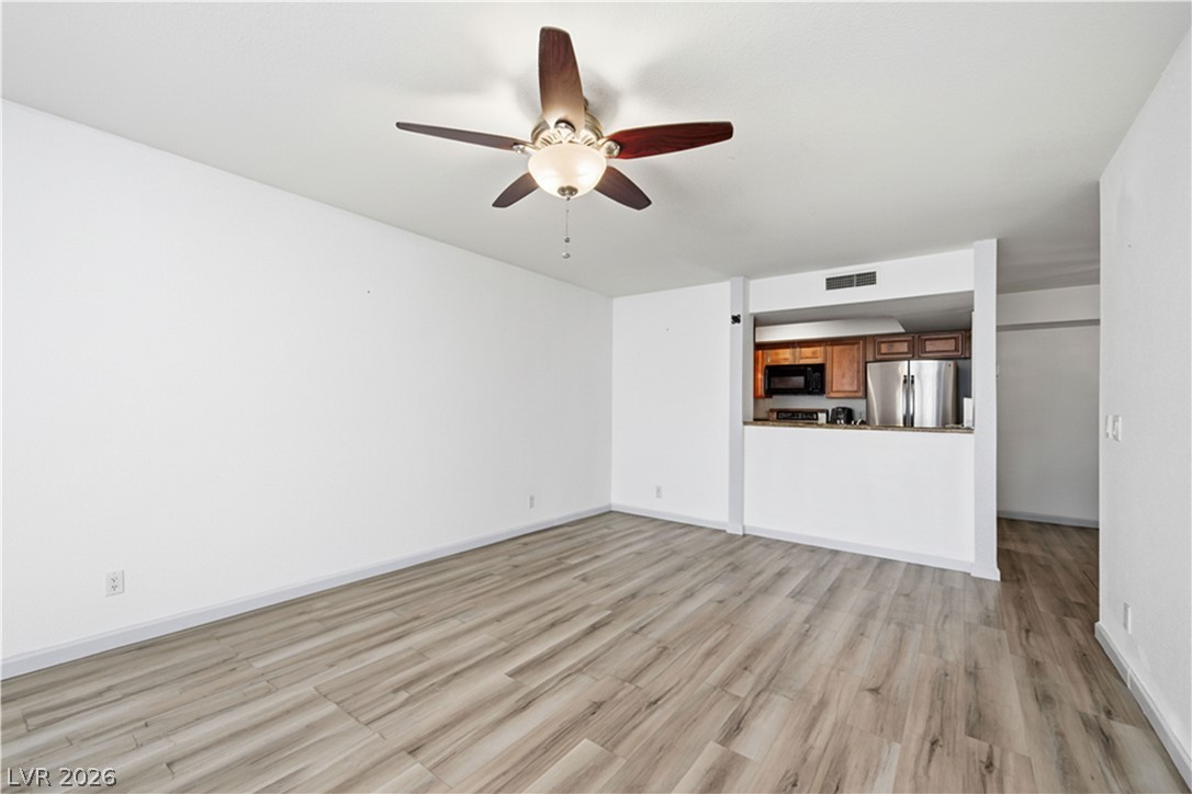 2838 Geary Place, Unit 4017 Las Vegas, NV 89109 - Photo 4 of 31 This charming living room offers ample seating space and a ceiling fan with a light fixture—perfect for movie nights, quiet mornings, or entertaining!