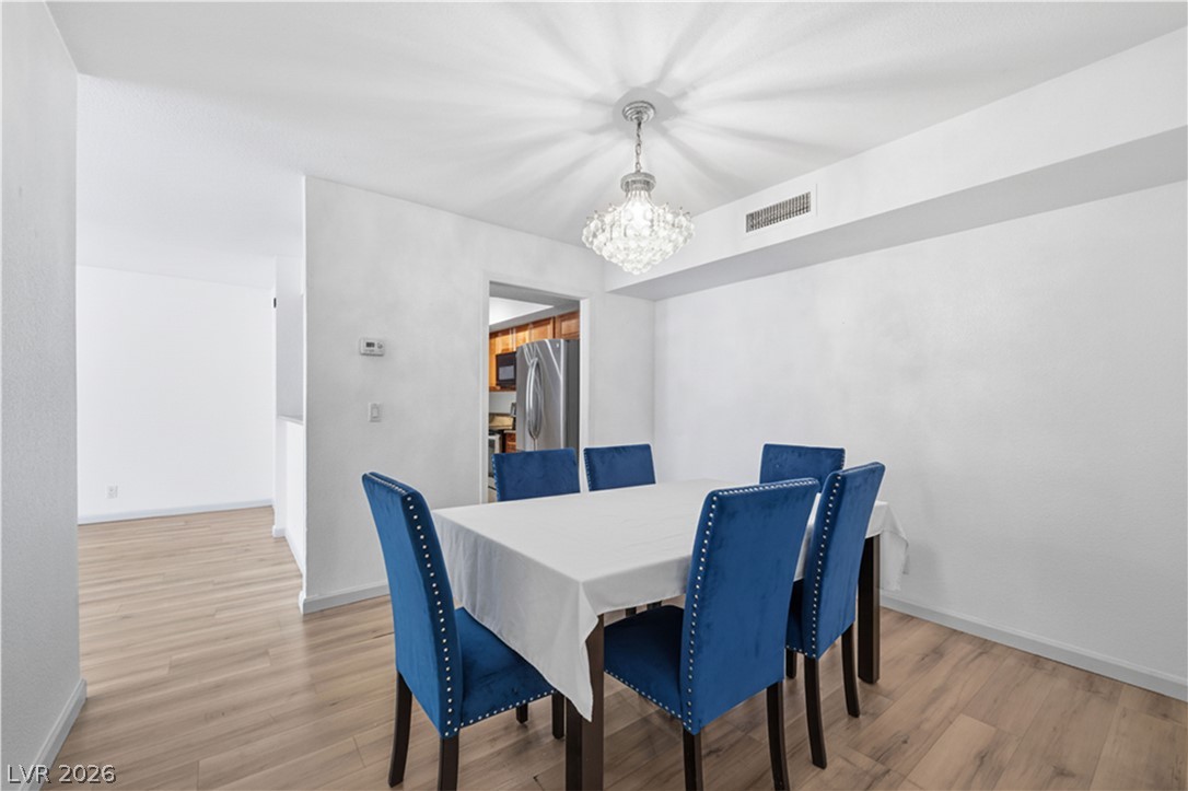 2838 Geary Place, Unit 4017 Las Vegas, NV 89109 - Photo 7 of 31 The dining area provides bonus storage and a smooth flow into the living room, with the kitchen conveniently positioned nearby- great for creating a comfortable dining setup that works for both daily routines and special occasions.