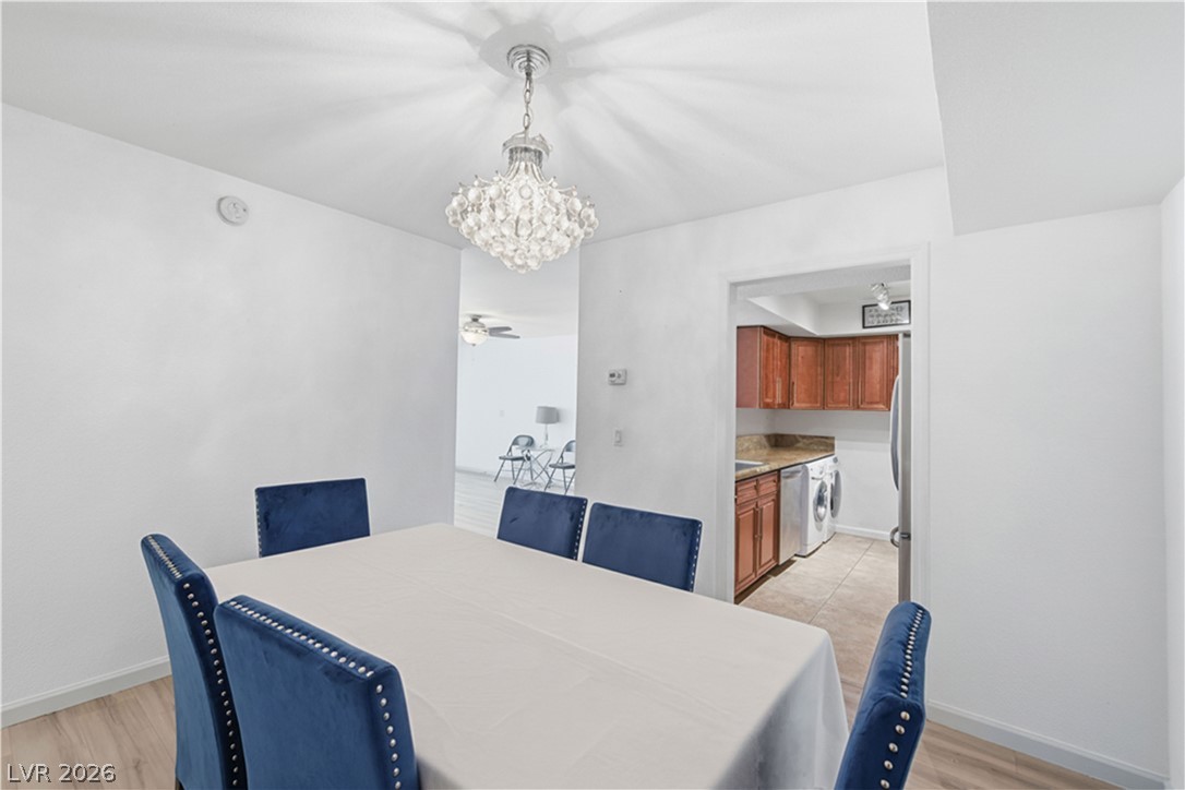 2838 Geary Place, Unit 4017 Las Vegas, NV 89109 - Photo 8 of 31 Enjoy meals under an elegant chandelier, with the kitchen close by to keep everything within reach.