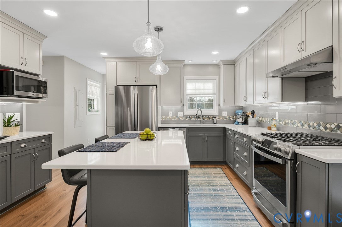 13366 Depot Road Hanover, VA 23069 - Photo 11 of 27 a kitchen with stainless steel appliances kitchen island granite countertop a sink stove and refrigerator