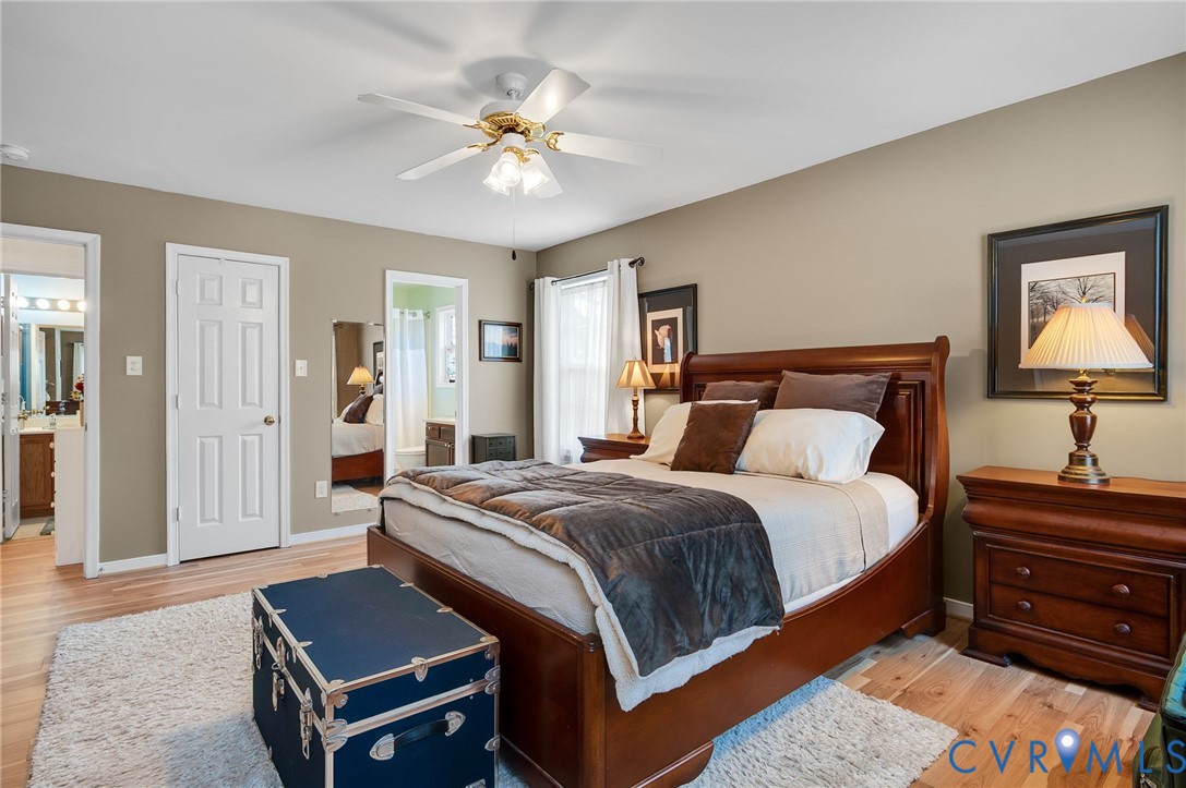 13366 Depot Road Hanover, VA 23069 - Photo 16 of 27 a bedroom with a bed and a chandelier