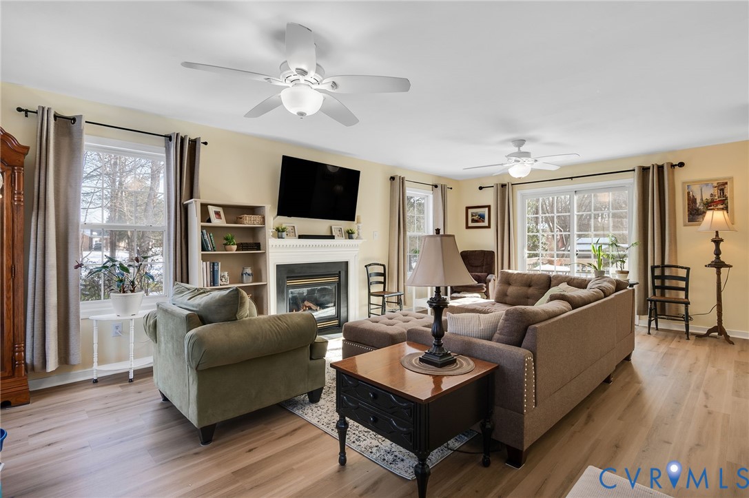13366 Depot Road Hanover, VA 23069 - Photo 6 of 27 a living room with furniture a fireplace a flat screen tv and a large window