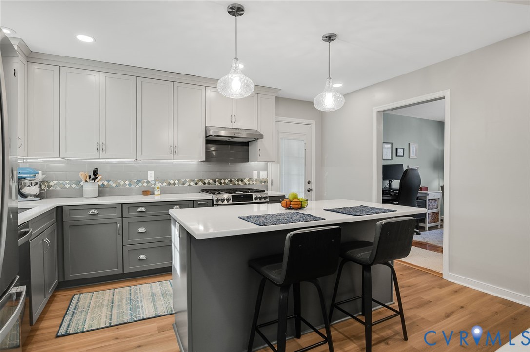 13366 Depot Road Hanover, VA 23069 - Photo 9 of 27 a kitchen with stainless steel appliances kitchen island granite countertop a sink a stove a refrigerator and white cabinets with wooden floor
