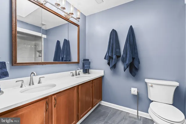 a bathroom with a toilet sink and mirror