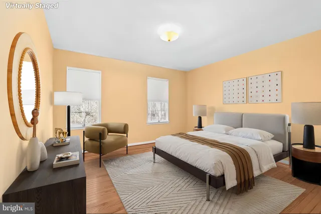 a bedroom with a bed a couch and dresser