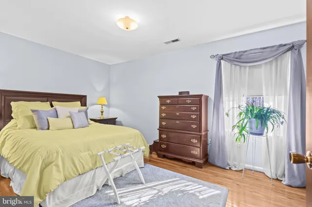 a bedroom with a bed and a potted plant