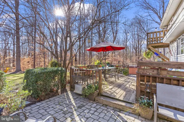 a view of a patio with a table and chairs under an umbrella