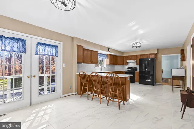 a living room with furniture and a dining table