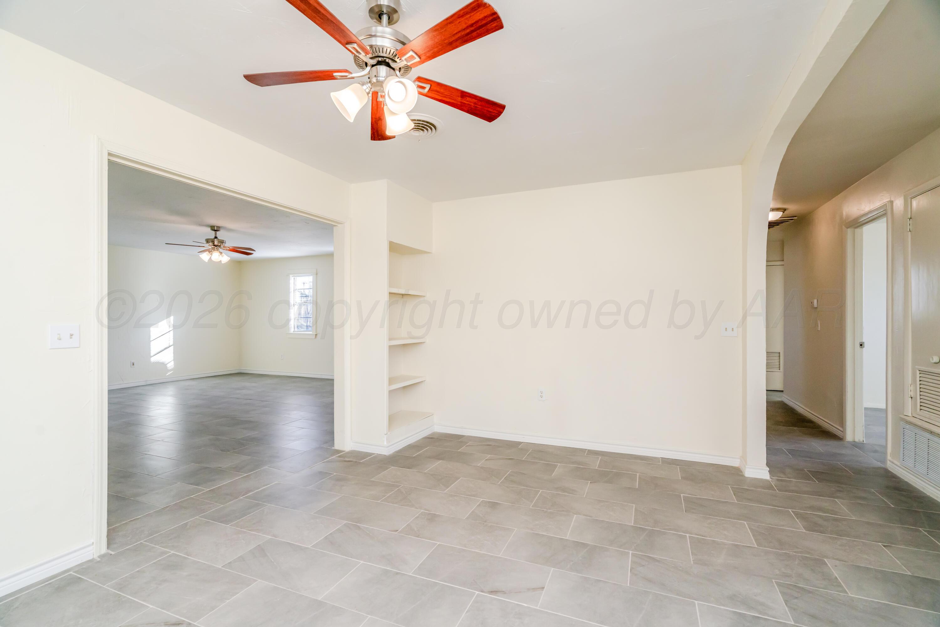 3102 Sequoia Street Amarillo, TX 79107 - Photo 7 of 21 a view of a hallway with wooden floor and a chandelier fan