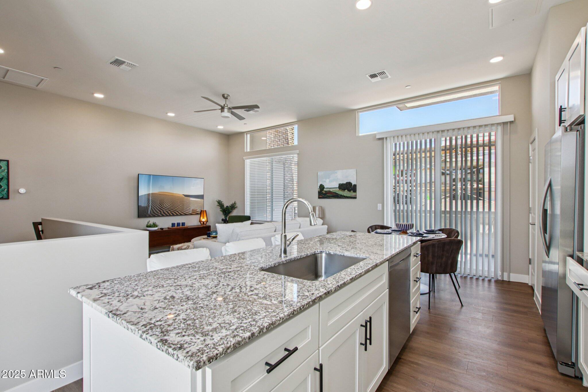 1927 South Recker Road, Unit 175 Mesa, AZ 85206 - Photo 13 of 34 a kitchen with granite countertop a sink counter top space and stainless steel appliances