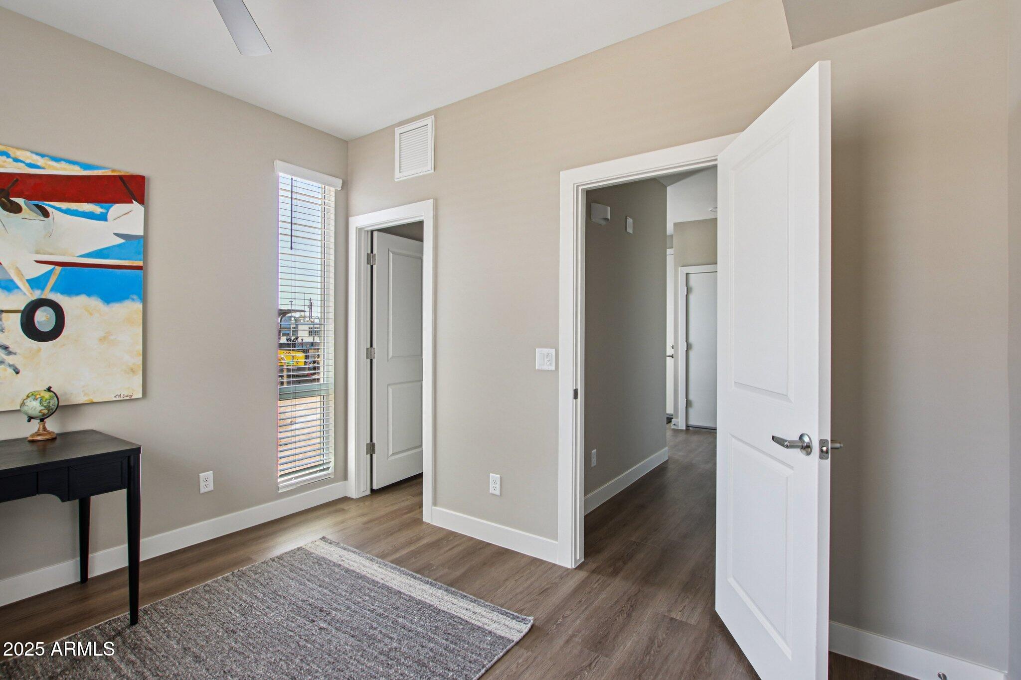 1927 South Recker Road, Unit 175 Mesa, AZ 85206 - Photo 16 of 34 a view of an empty room with wooden floor and closet