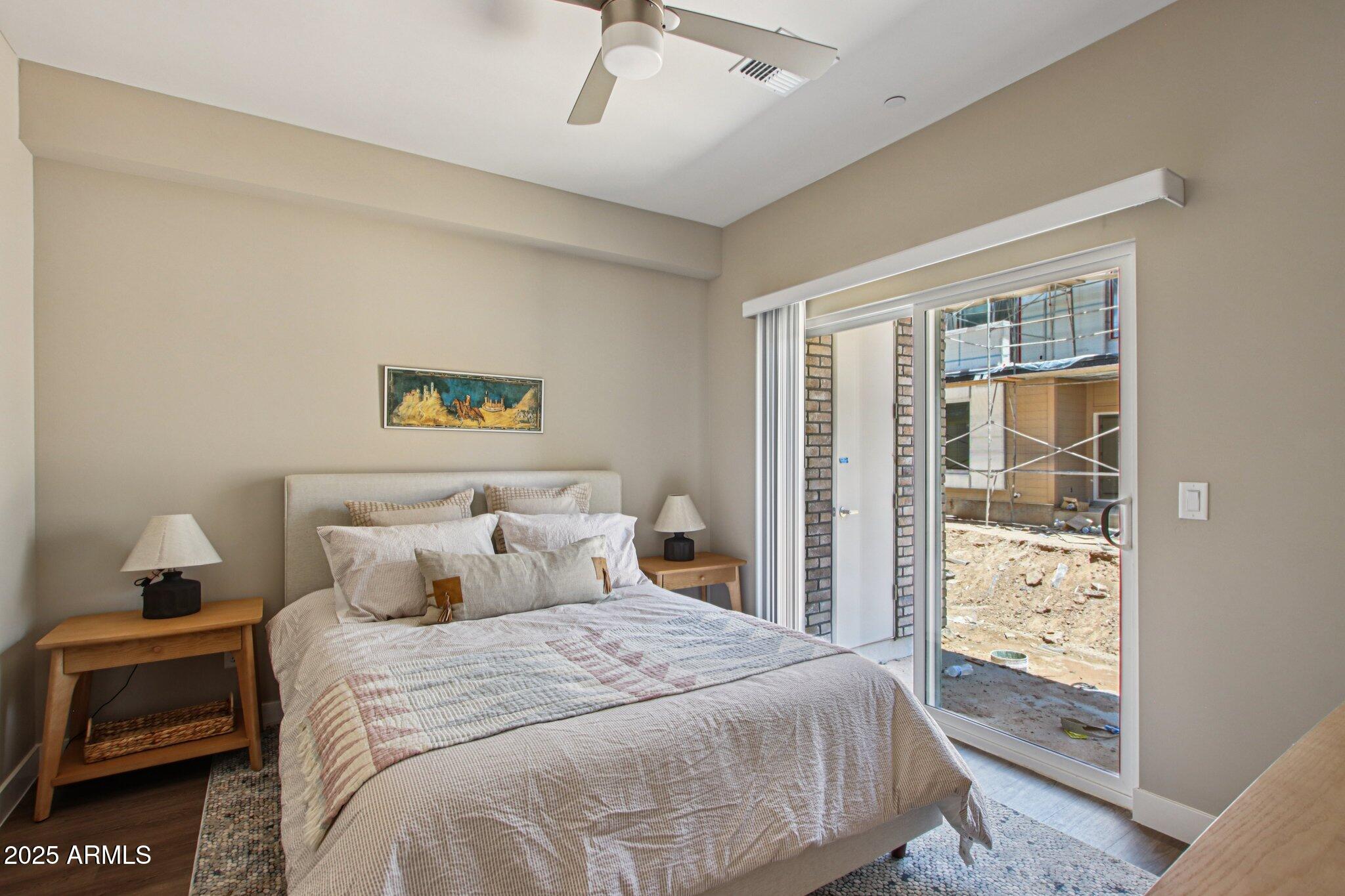 1927 South Recker Road, Unit 175 Mesa, AZ 85206 - Photo 18 of 34 a bedroom with a large bed and a window