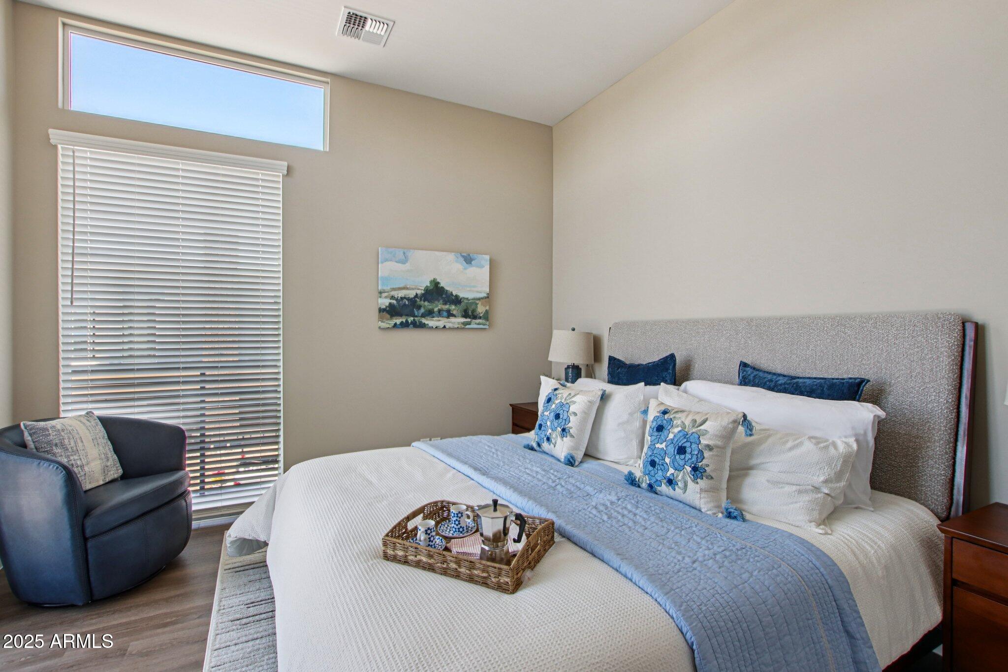 1927 South Recker Road, Unit 175 Mesa, AZ 85206 - Photo 24 of 34 a bedroom with a bed and a couch