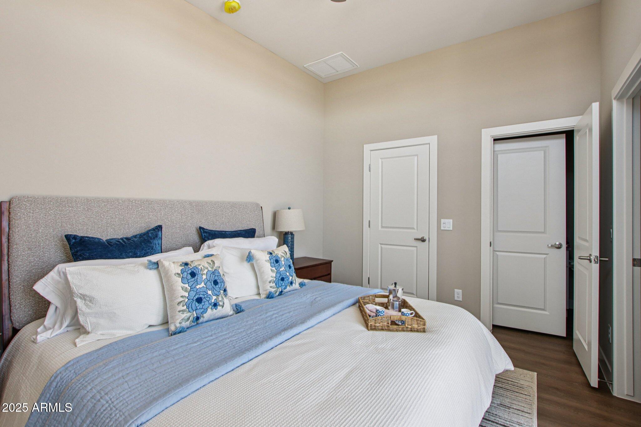 1927 South Recker Road, Unit 175 Mesa, AZ 85206 - Photo 25 of 34 a bedroom with a bed and wooden floor