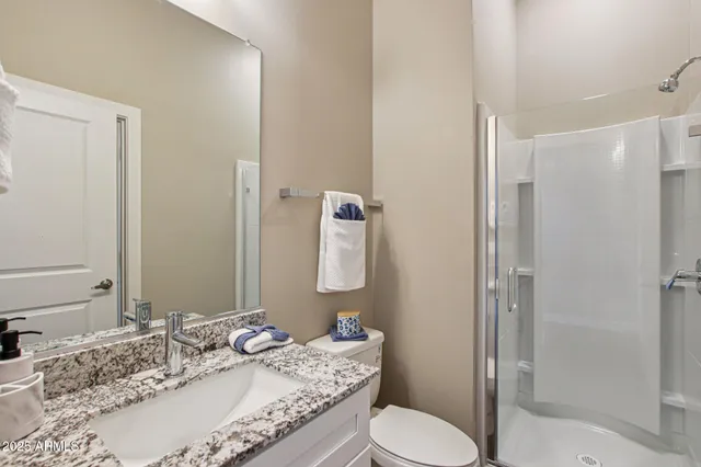 a porch with a chair and a potted plant next to a window