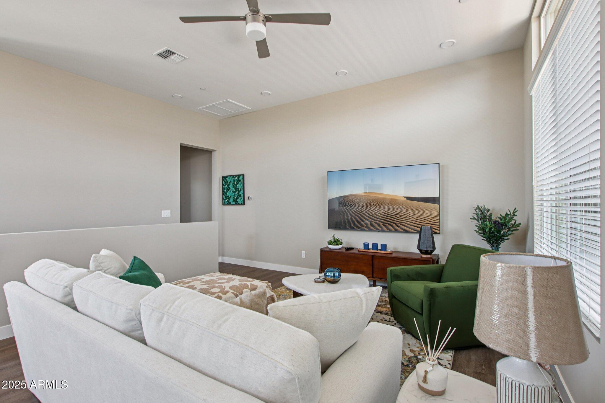 1927 South Recker Road, Unit 175 Mesa, AZ 85206 - Photo 4 of 34 a living room with furniture and a flat screen tv