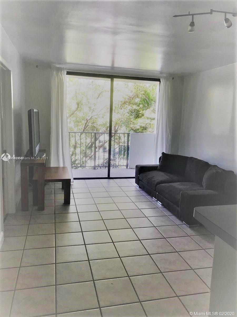 1673 Bay Road, Unit 303 Miami Beach, FL 33139 - Photo 4 of 16 a living room with a large window