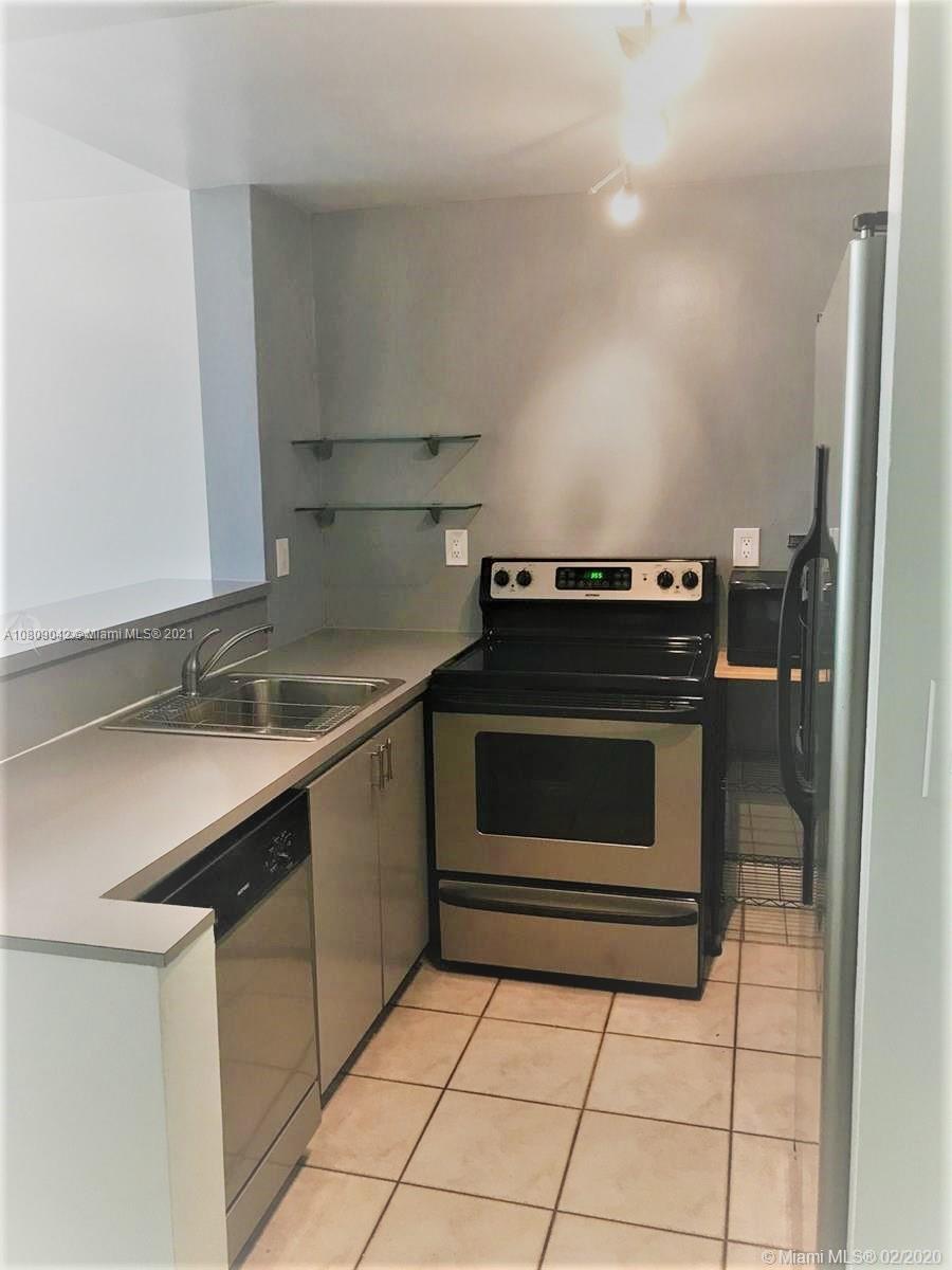 1673 Bay Road, Unit 303 Miami Beach, FL 33139 - Photo 7 of 16 a kitchen with a stove and a sink