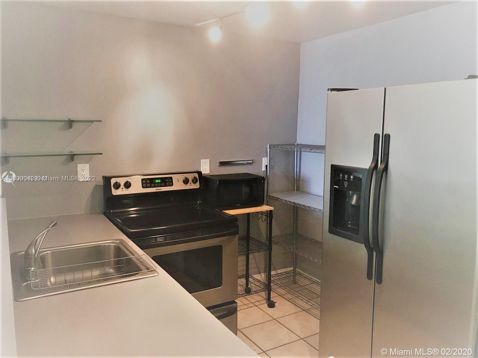 1673 Bay Road, Unit 303 Miami Beach, FL 33139 - Photo 8 of 16 a utility room with washer and dryer