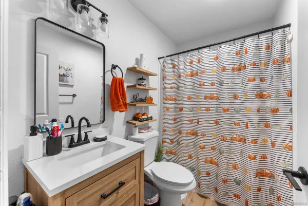 a bedroom with a bed and the view of bathroom