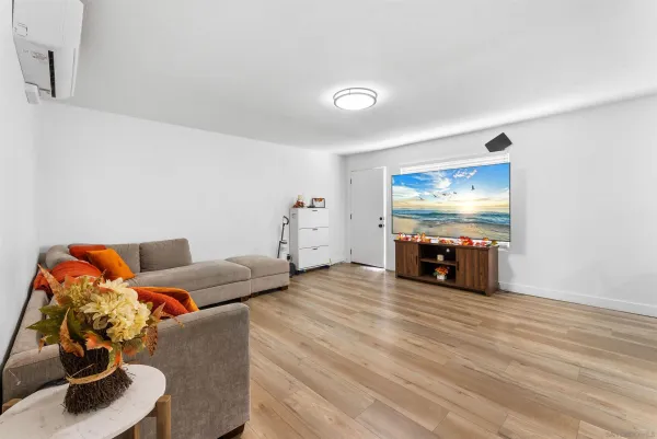 a living room with furniture and wooden floor