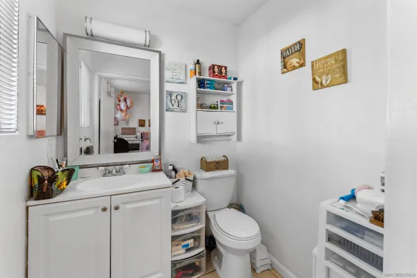 a bedroom with furniture and a flat screen tv