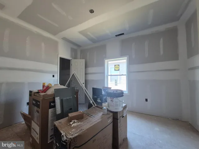 a living room with furniture a window and a wooden floor