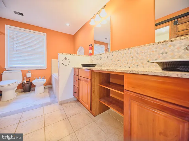 a bathroom with a sink a toilet and bathtub