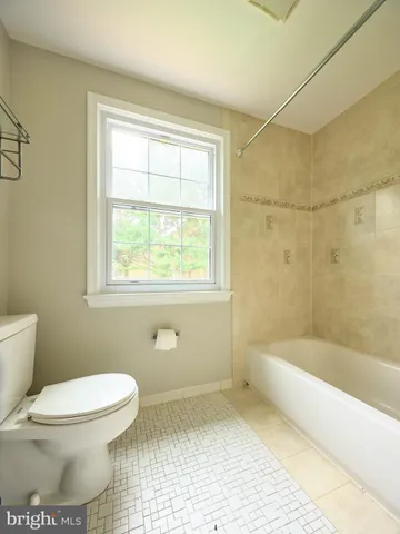 a white toilet sitting next to a bathroom sink