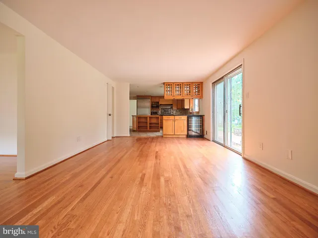 a view of empty room with wooden floor and fireplace
