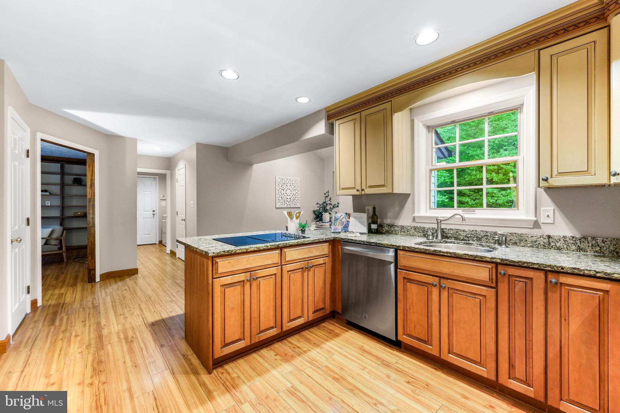 1074 Foxcroft Run Annapolis, MD 21401 - Photo 23 of 66 a kitchen with stainless steel appliances granite countertop wooden cabinets a sink and dishwasher a stove with wooden floor