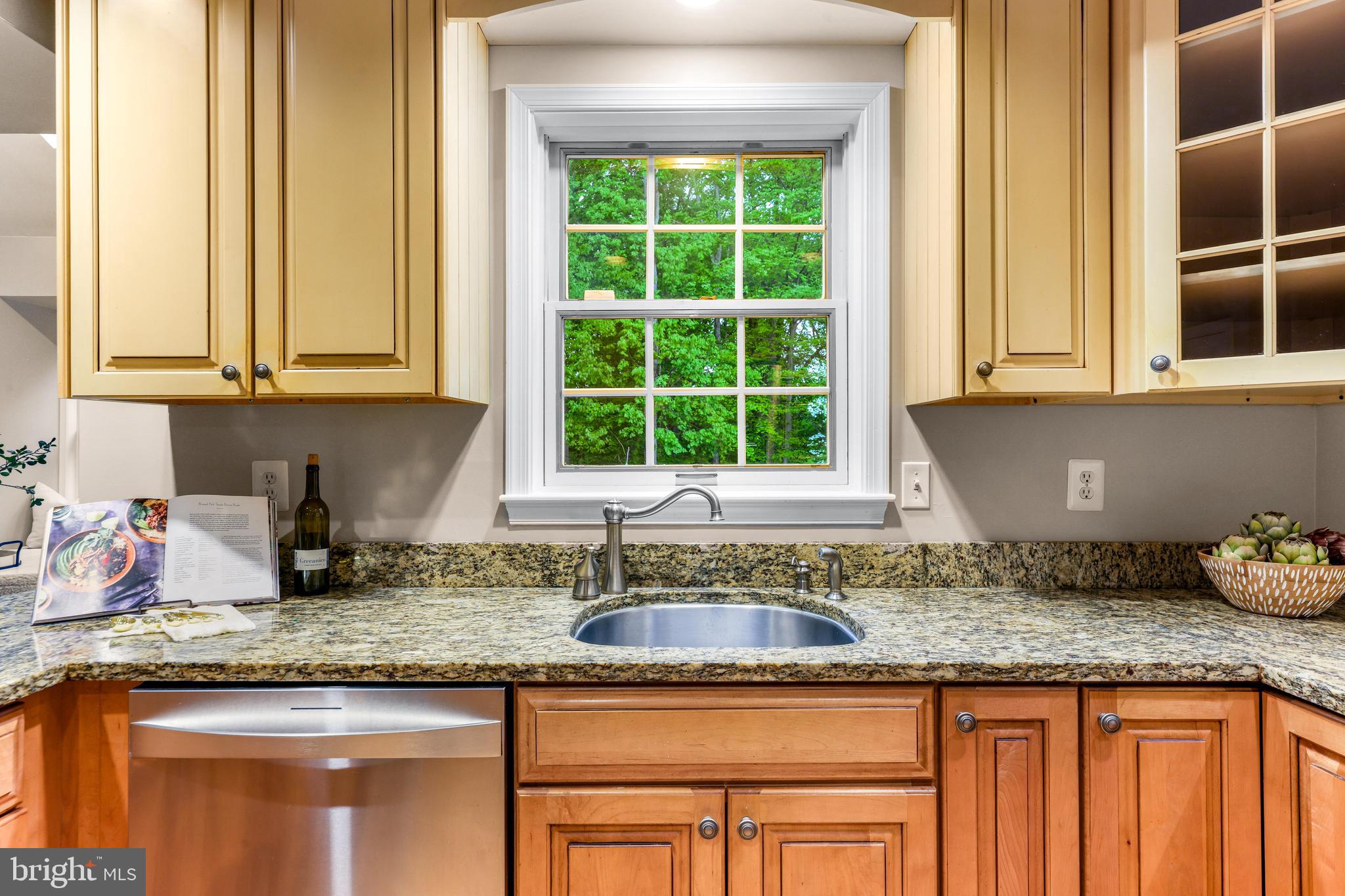 1074 Foxcroft Run Annapolis, MD 21401 - Photo 24 of 66 a kitchen with granite countertop wooden cabinets a sink and a window