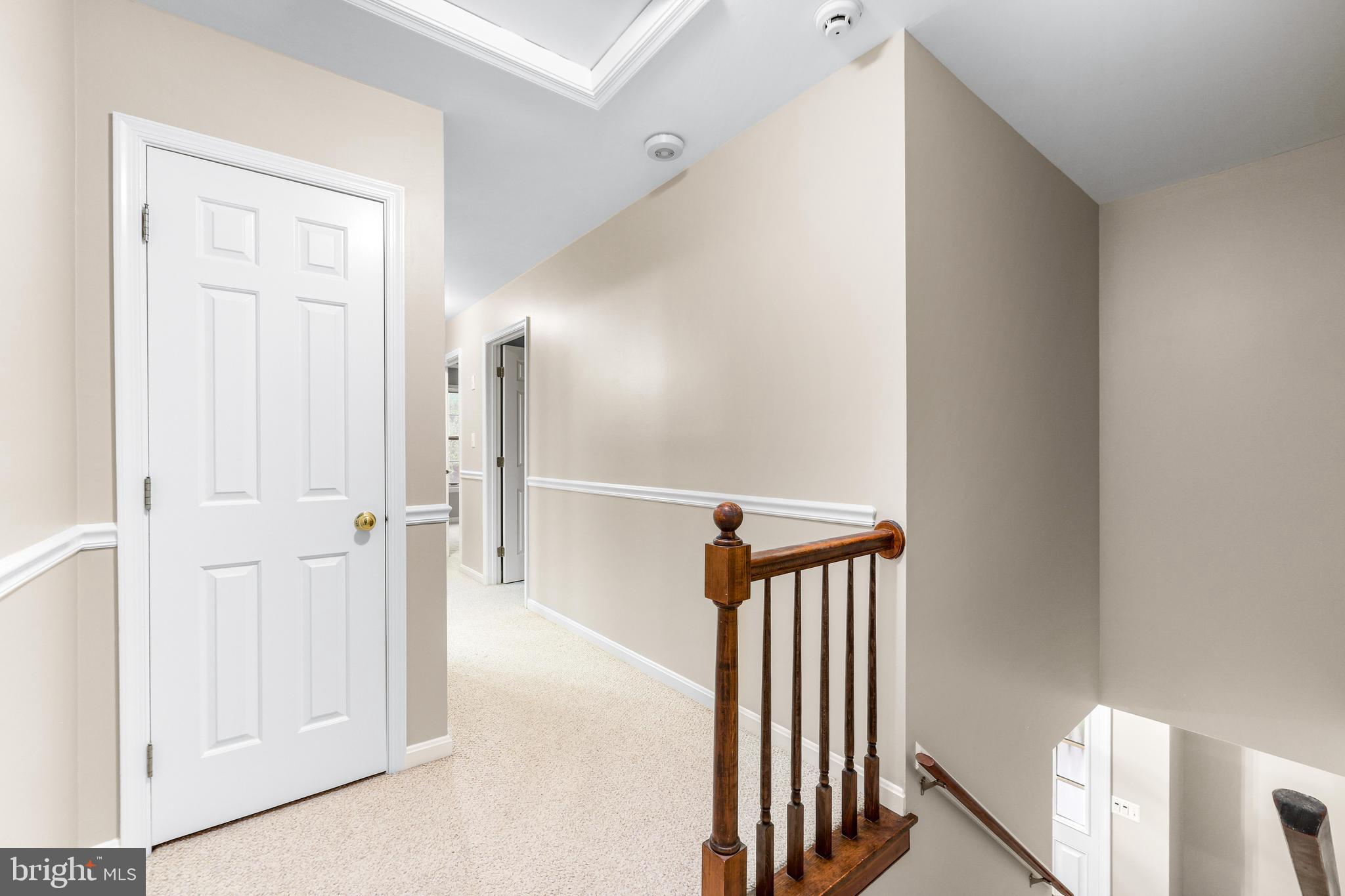 1074 Foxcroft Run Annapolis, MD 21401 - Photo 32 of 66 a view of a hallway with wooden floor and staircase
