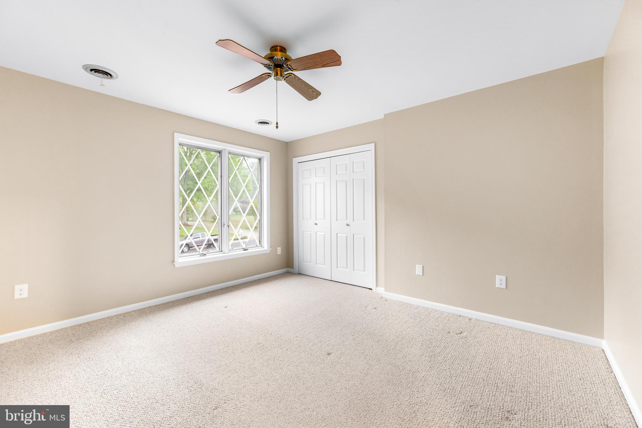 1074 Foxcroft Run Annapolis, MD 21401 - Photo 66 of 66 en empty room with windows and ceiling fan