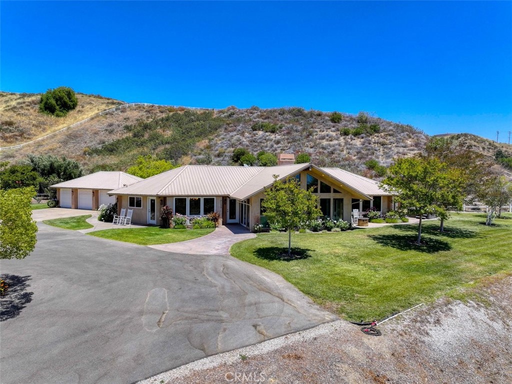 31233 Romero Canyon Road Castaic, CA 91384 - Photo 1 of 38 a view of a house with a yard and sitting area