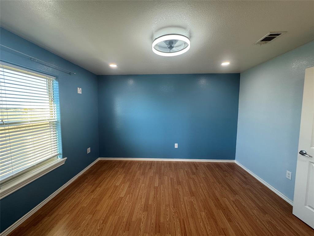528 County Road 4227 Decatur, TX 76234 - Photo 12 of 22 an empty room with wooden floor and windows