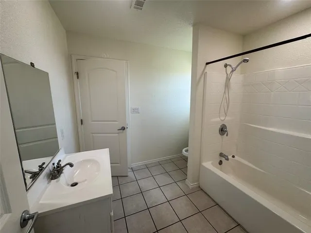 a bathroom with a bathtub and shower