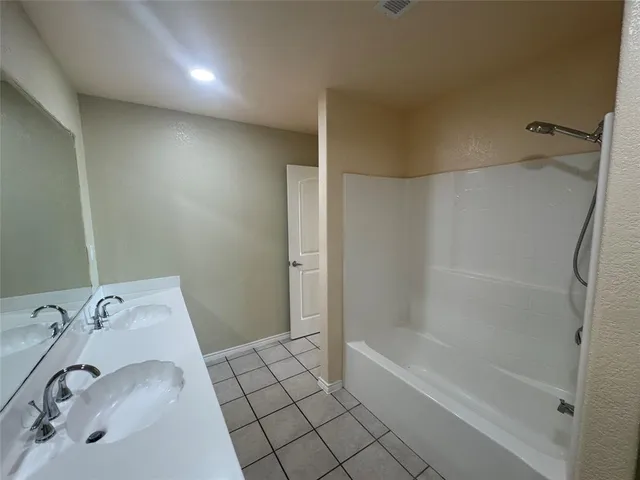 a bathroom with a bathtub and shower