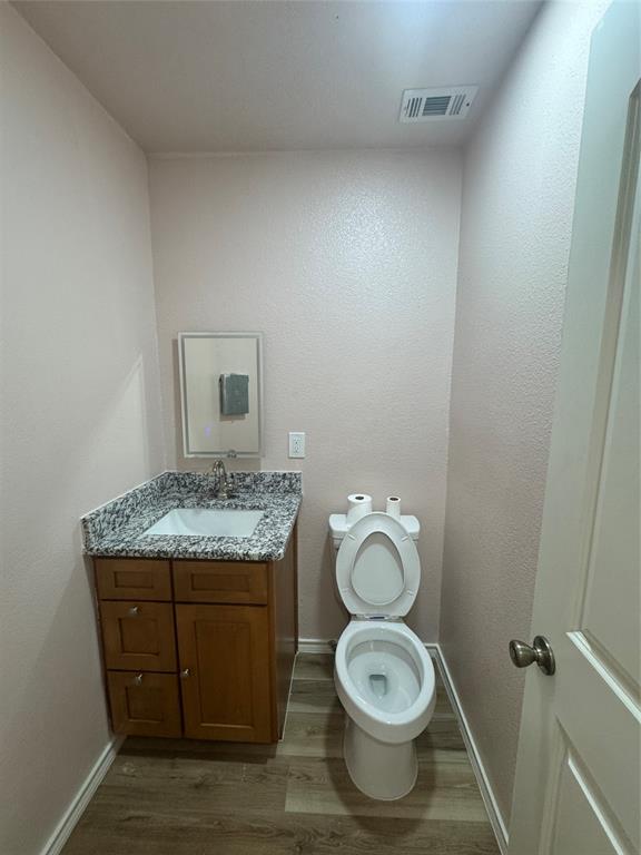 528 County Road 4227 Decatur, TX 76234 - Photo 10 of 22 a bathroom with a granite countertop toilet and a sink