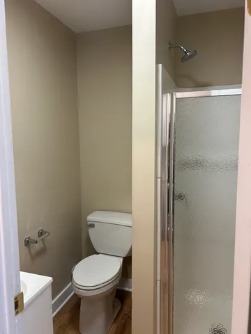 a white toilet sitting next to a bathroom sink