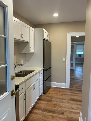 a kitchen with stainless steel appliances granite countertop a refrigerator and a stove