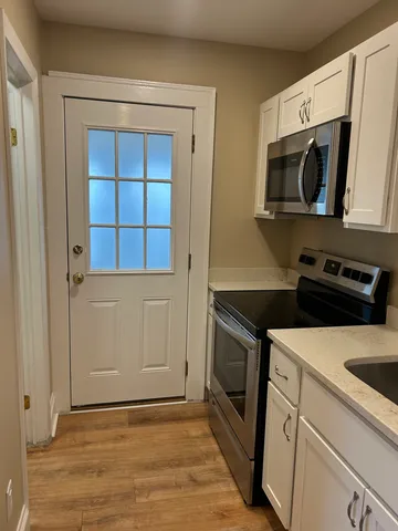 a kitchen with a microwave and a stove