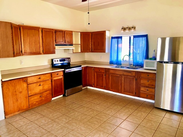43-971 Namilimili Lane Paauilo, HI 96776 - Photo 6 of 13 a kitchen with stainless steel appliances granite countertop a stove a sink dishwasher and a refrigerator