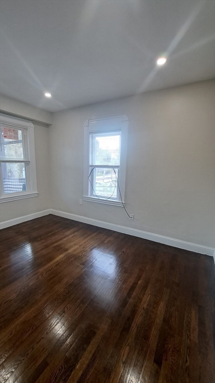 7 Samoset Street, Unit 2 Boston, MA 02124 - Photo 6 of 12 an empty room with wooden floor and windows