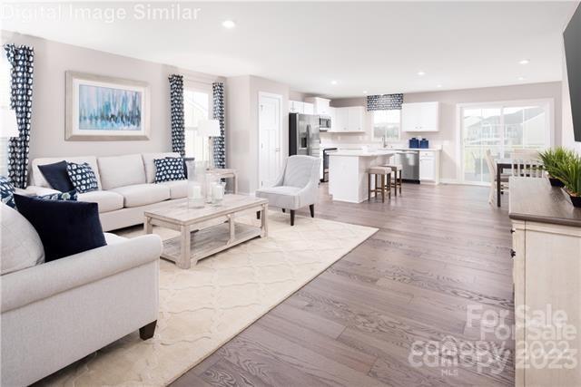 559 Grandiflora Avenue, Unit 108 Lancaster, SC 29720 - Photo 5 of 10 a living room with furniture and view of kitchen