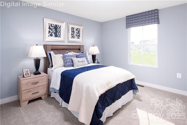 559 Grandiflora Avenue, Unit 108 Lancaster, SC 29720 - Photo 8 of 10 a bedroom with bed and a window