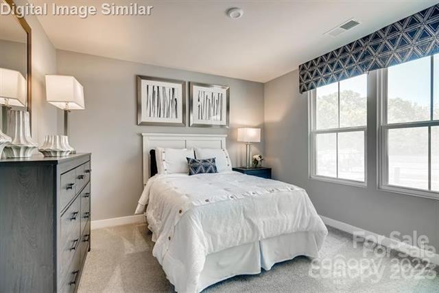 559 Grandiflora Avenue, Unit 108 Lancaster, SC 29720 - Photo 9 of 10 a bedroom with a bed and a window